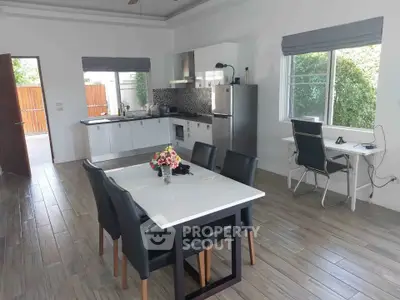 Modern open-plan kitchen and dining area with sleek design and natural light.