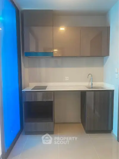 Modern compact kitchen with sleek cabinetry and minimalist design
