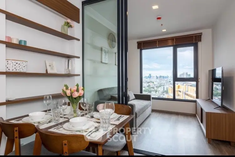Modern living room with dining area and city view, featuring stylish decor and natural light.