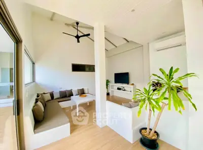 Modern living room with sleek design, featuring built-in seating, a ceiling fan, and a potted plant for a fresh ambiance.