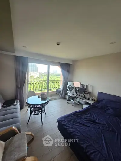 Spacious bedroom with balcony view and modern furnishings