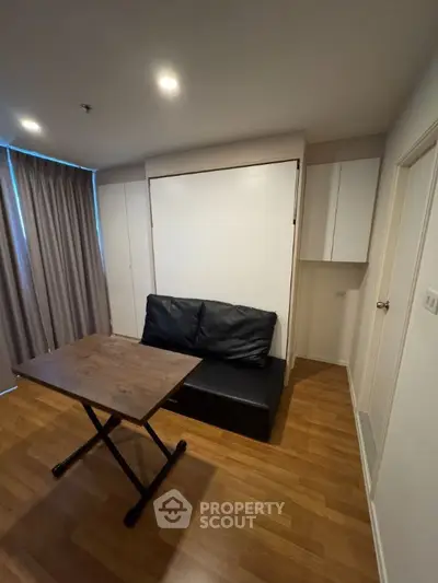 Modern living room with convertible furniture and wooden flooring