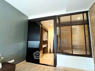 Modern bedroom with walk-in closet and stylish blinds