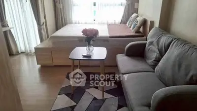 Cozy bedroom with sofa and stylish decor, perfect for modern living.