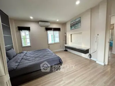 Spacious modern bedroom with stylish decor and natural light