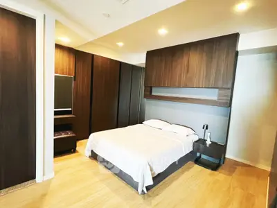 Modern bedroom with sleek wooden accents and ambient lighting