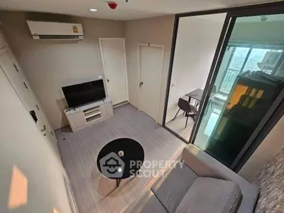 Modern living room with sleek furniture and balcony view in urban apartment