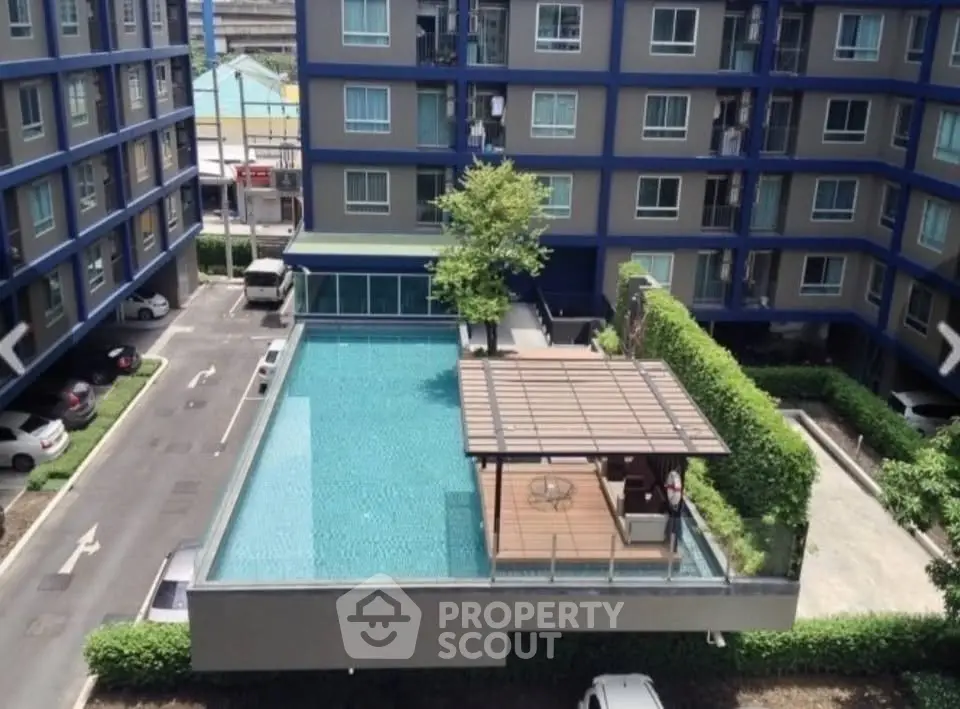 Modern apartment complex with rooftop pool and lush greenery, offering urban living with leisure amenities.