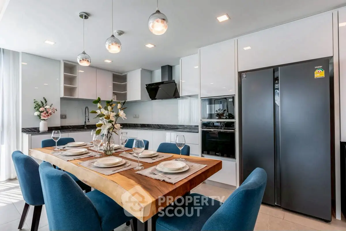 Modern kitchen with elegant dining setup and sleek appliances
