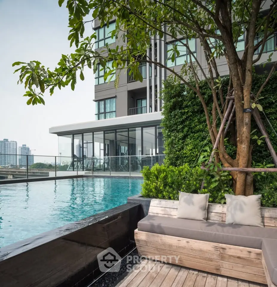 Luxurious rooftop pool with stunning city view and modern seating area.