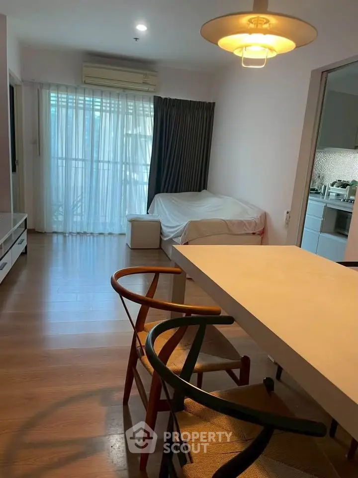 Modern living room with stylish furniture and open kitchen layout in a cozy apartment.