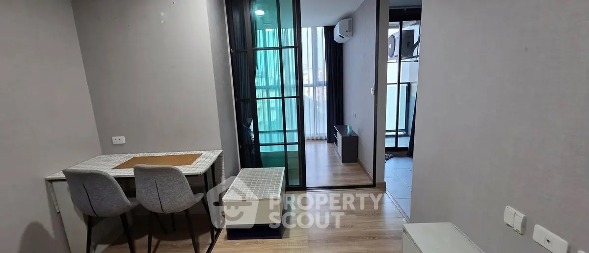 Modern apartment interior with dining area and balcony view
