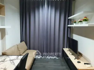 Cozy living room with modern decor and flat-screen TV, perfect for relaxation.