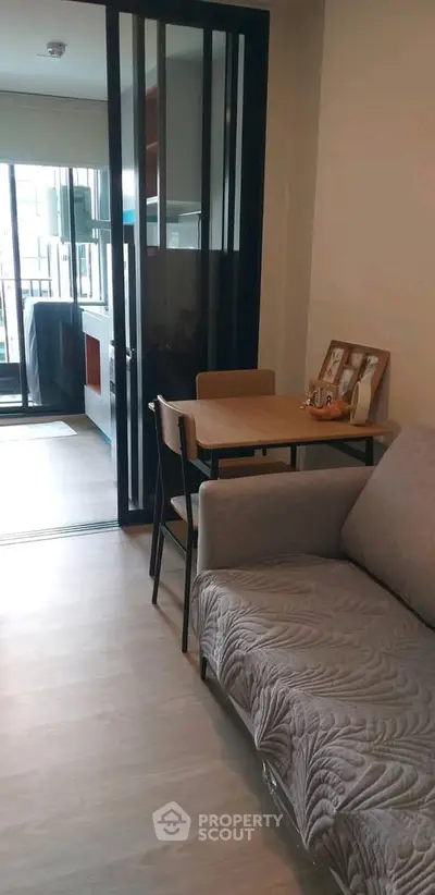 Modern living room with cozy sofa and dining area in open layout apartment