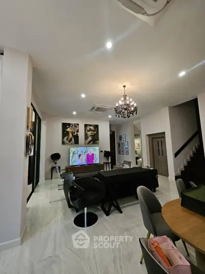 Luxurious modern living room with elegant decor and chandelier lighting