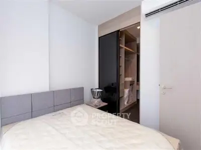 Modern bedroom with built-in closet and air conditioning unit