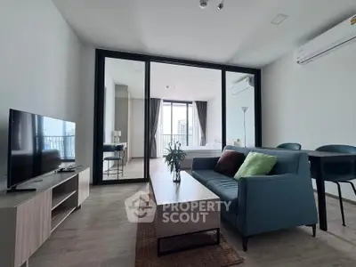 Modern living room with sleek furniture and city view, featuring a stylish open layout and natural light.