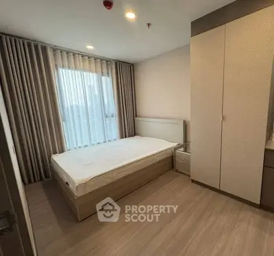 Modern bedroom with sleek design, featuring a single bed and built-in wardrobe, ideal for urban living.