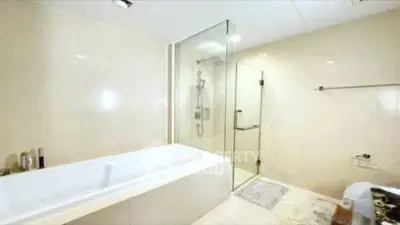 Luxurious bathroom with glass shower and modern bathtub