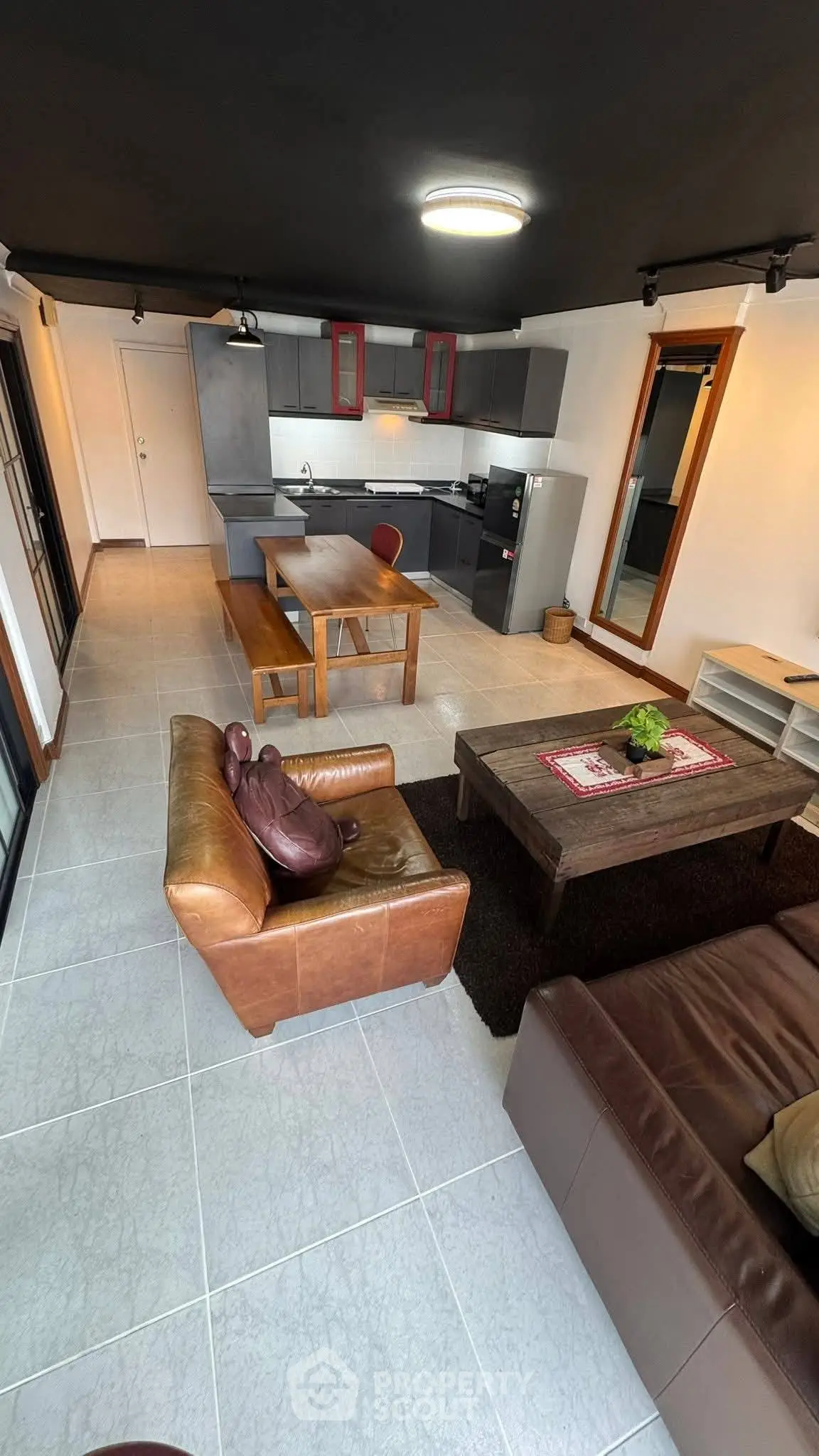 Modern open-plan living room with stylish kitchen and cozy seating area