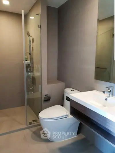 Modern bathroom with sleek design, glass shower, and contemporary fixtures.