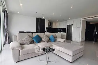 Spacious modern living room with sleek kitchen and stylish decor