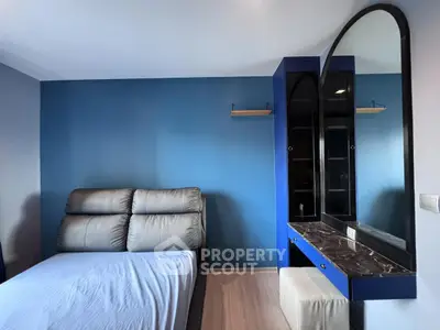 Modern bedroom with blue accent wall and stylish furniture