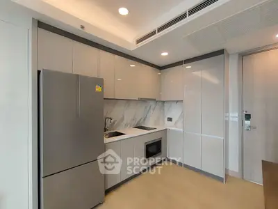 Modern kitchen with sleek cabinetry and built-in appliances in a stylish apartment.