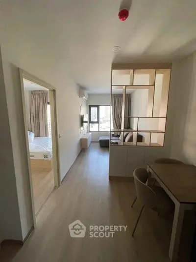 Modern apartment interior with open layout, featuring a cozy living room and dining area.