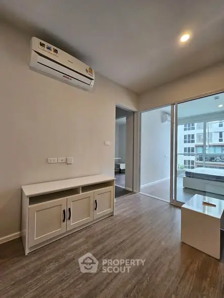 Modern living room with air conditioning and balcony view in a stylish apartment.