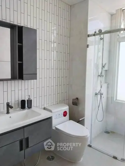 Modern bathroom with sleek fixtures and glass shower enclosure