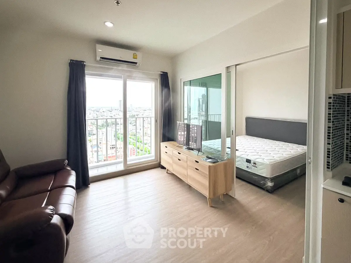 Modern apartment with spacious living room and bedroom, featuring large windows and city view.