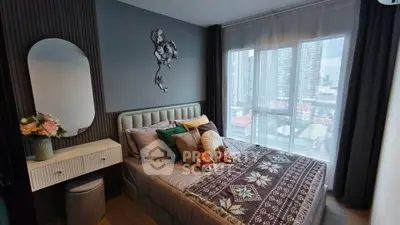 Cozy bedroom with modern decor and city view from large windows