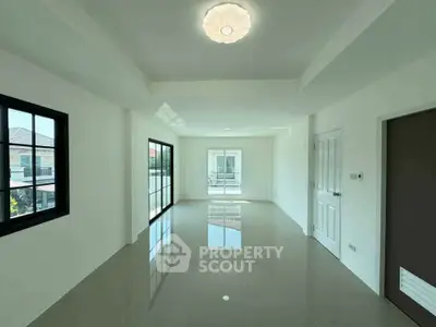 Spacious and bright living room with modern design and large windows.
