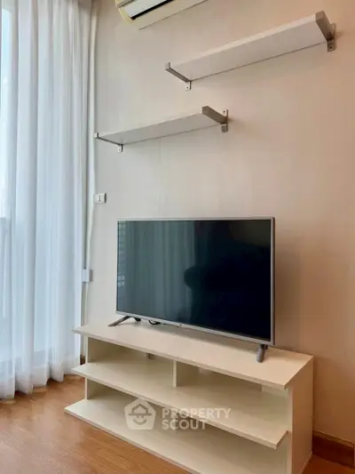 Modern living room with TV and minimalist shelving