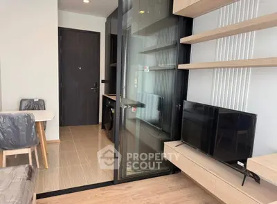 Modern apartment interior with open layout, featuring a sleek kitchen and cozy living area.