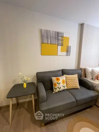 Chic living room with modern gray sofa, stylish decor, and cozy ambiance.