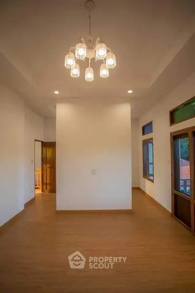 Spacious interior with elegant lighting and wooden flooring, perfect for modern living.