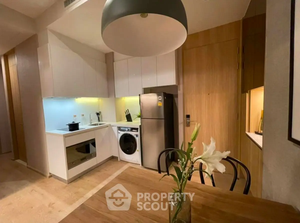 Modern kitchen with sleek appliances and elegant dining area
