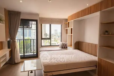 Modern bedroom with large window and city view, featuring built-in storage and stylish decor.