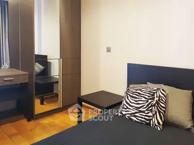 Modern bedroom with stylish zebra print pillows and sleek wooden furniture