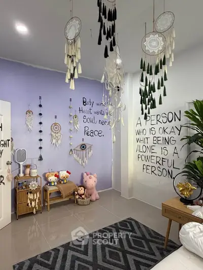 Charming bedroom with dreamcatchers and motivational quotes on pastel walls.