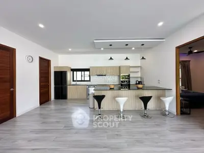 Spacious modern kitchen with sleek design and island seating in open layout