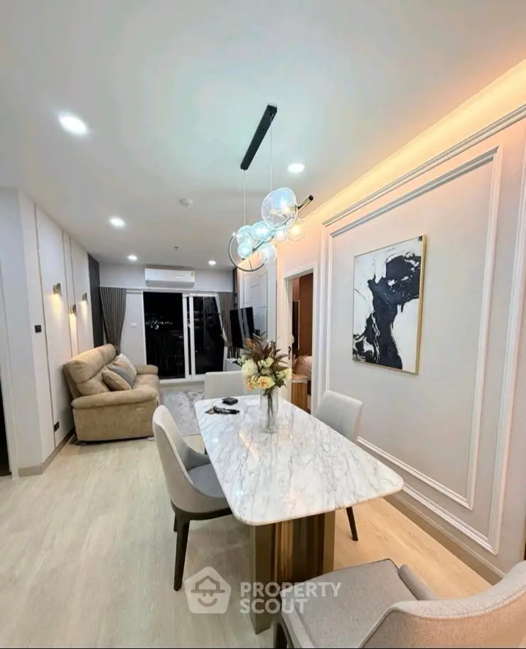 Luxurious modern living room with elegant marble dining table and stylish lighting in a contemporary apartment.