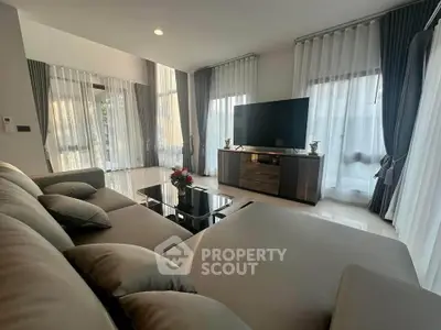 Spacious modern living room with large windows and elegant decor