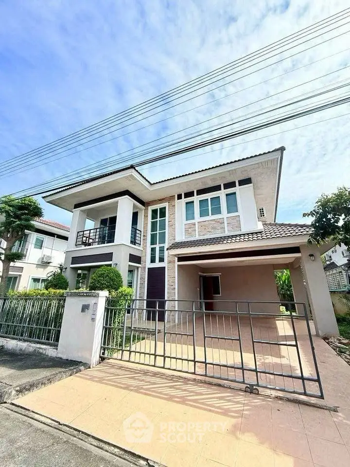 Modern two-story house with spacious driveway and lush greenery