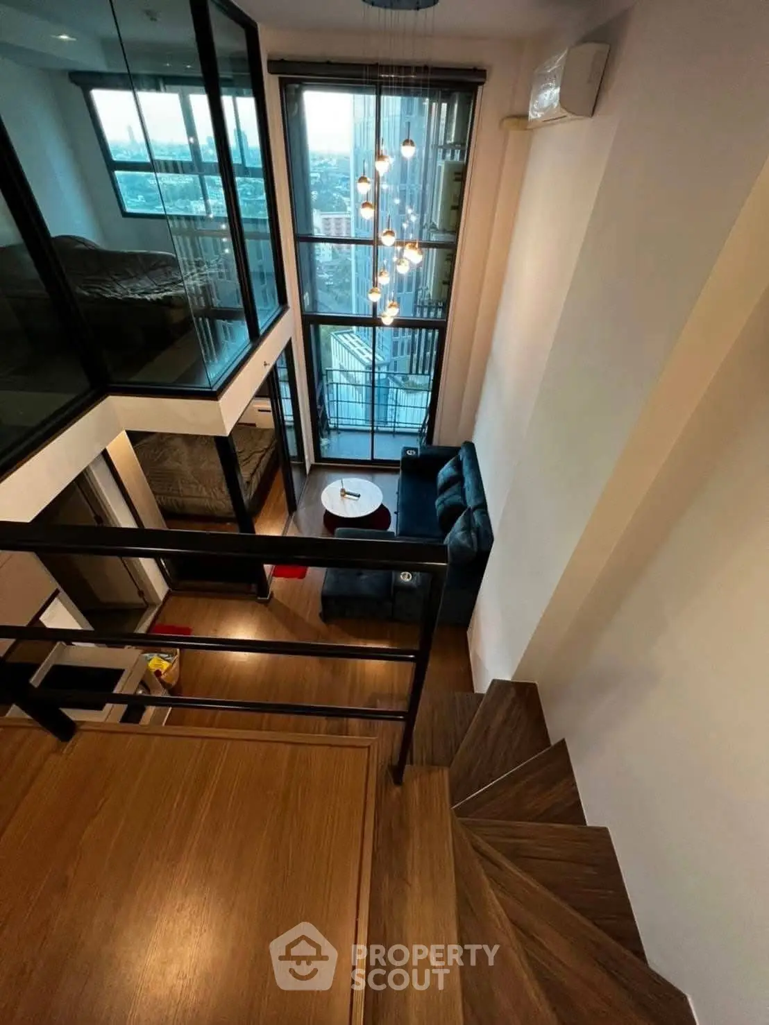 Stunning duplex apartment with modern design and large windows offering city views.