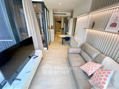 Modern living room with sleek design, featuring a leather sofa, wall-mounted TV, and stylish decor.