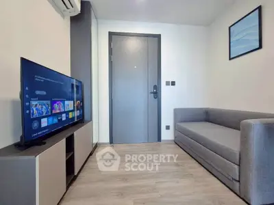 Modern living room with sleek furniture and smart TV, perfect for cozy relaxation.