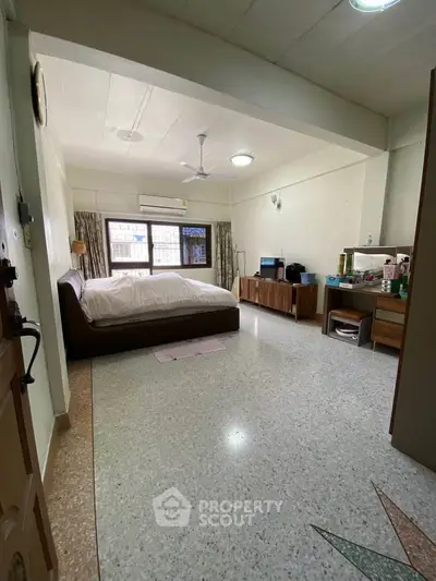 Spacious bedroom with modern furnishings and natural light